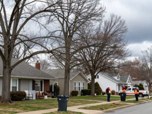 Plymouth MI residents securing outdoor items and inspecting trees for storm preparation