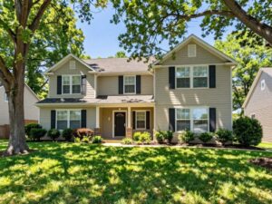 Residential landscape in Plymouth MI with strategically planted trees for energy efficiency.