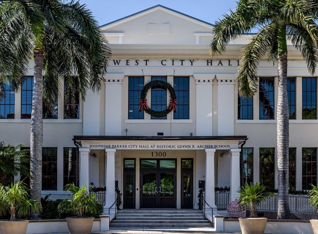 Civic building entrance framed by palm trees
